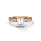 Top-down view of a 4 CT emerald cut lab diamond ring set in rose gold with micro-pavé diamond band.