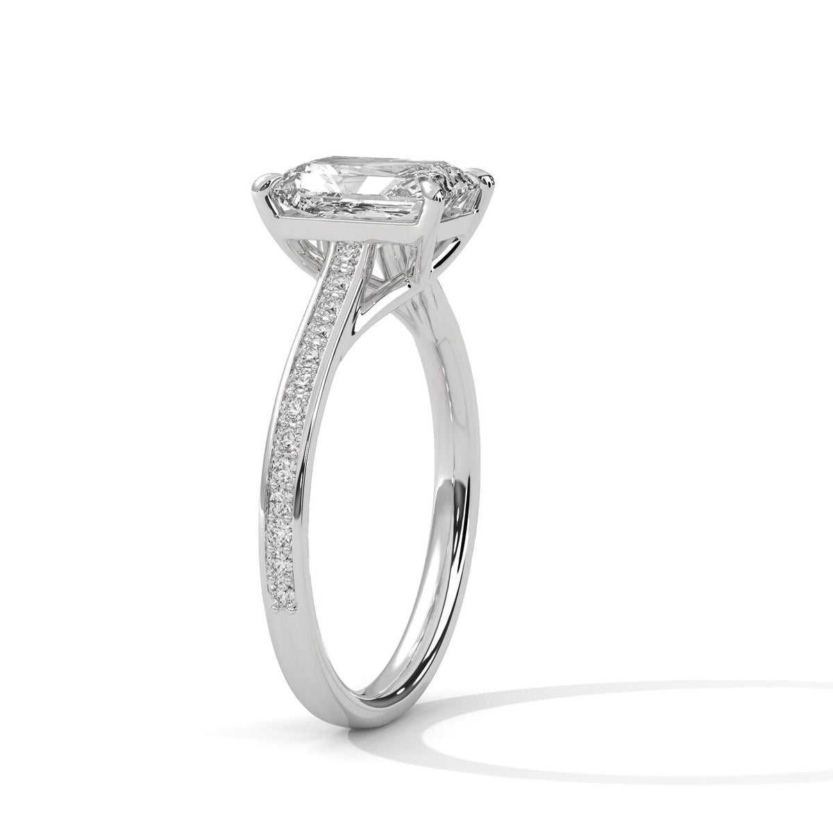 Side profile perspective of a white gold 4 CT emerald cut lab grown diamond ring with diamond-encrusted band.