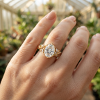 On-hand view of a 3 CT oval cut lab grown diamond engagement ring in yellow gold with vintage nature-inspired band.