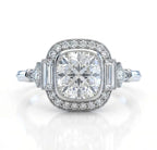 Front-facing render of a vintage-inspired 3 CT cushion cut lab grown diamond engagement ring with a milgrain halo and baguette side stones on a white background.