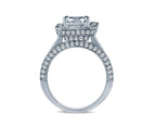 Direct side profile of a radiant cut diamond halo ring showcasing the elevated architectural setting, hidden halo collar, and diamond-encrusted split shank band.