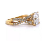Side profile view of a yellow gold 4 CT cushion cut lab grown diamond engagement ring featuring a twisted infinity shank set with micro-pave diamonds.