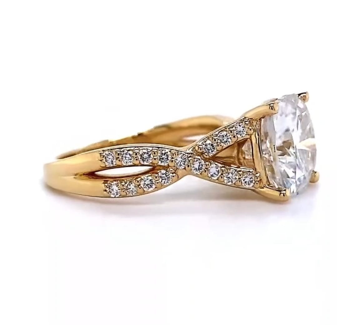 Side profile view of a yellow gold 4 CT cushion cut lab grown diamond engagement ring featuring a twisted infinity shank set with micro-pave diamonds.