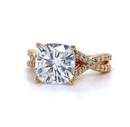 Direct top-down view of a stunning 4 carat cushion cut diamond engagement ring showcasing its brilliant facets and the yellow gold infinity diamond band.