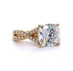 Slightly angled top view emphasizing the massive proportions of the 4 CT cushion lab diamond and the elegant sweeping curves of the twisted pave shank.