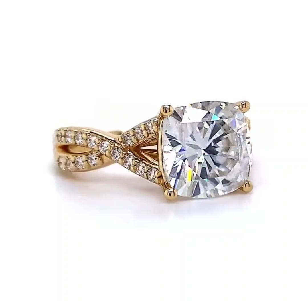 Slightly angled top view emphasizing the massive proportions of the 4 CT cushion lab diamond and the elegant sweeping curves of the twisted pave shank.