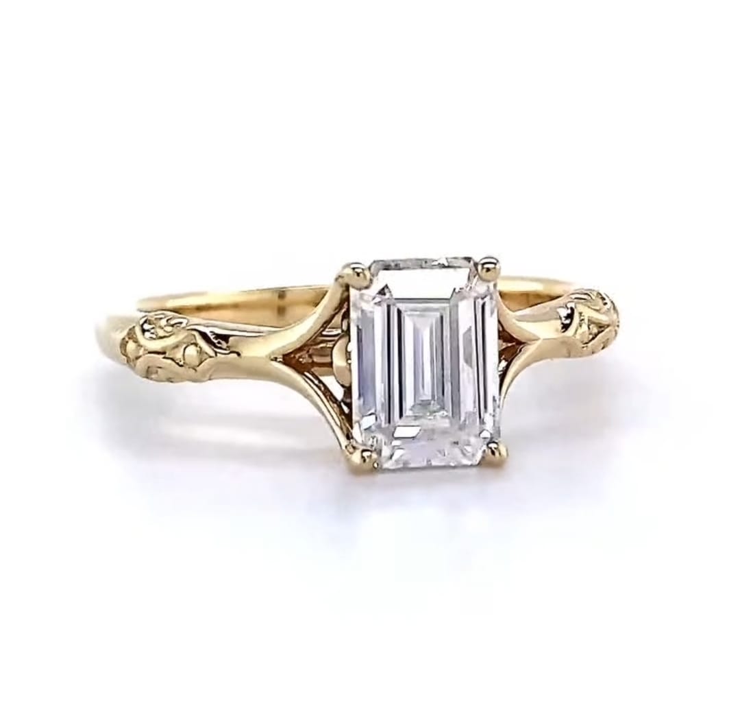 Direct front view of a 3 carat emerald cut lab grown diamond solitaire ring featuring intricate vintage-inspired engraved shoulders.