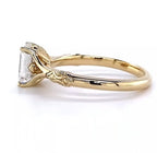 Alternate side profile view showcasing the warm yellow gold band and raised prong basket supporting the emerald cut center stone.