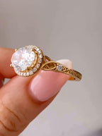 Close-up view of the Celtic twist shoulder, accent side diamond, and vintage relief scrollwork on the gold band.