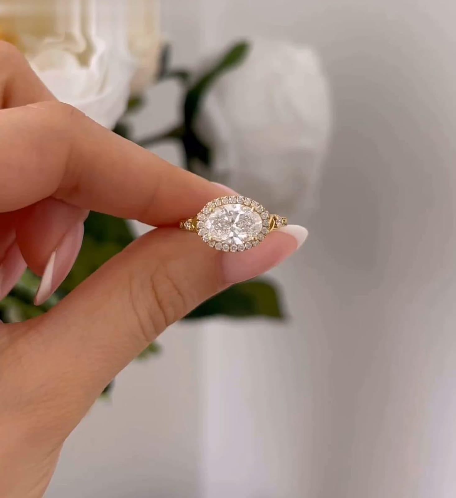 Directly overhead view highlighting the East-West horizontal placement of the 3 carat oval center stone and micro-pave halo.