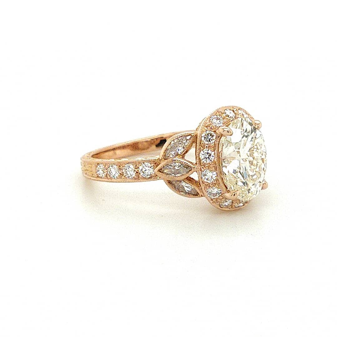 Side angle displaying the marquise leaf side accents and pavé halo of the 3 carat oval lab grown diamond ring