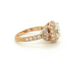 Close-up side profile showing the vintage scrollwork and leaf setting on the rose gold engagement ring