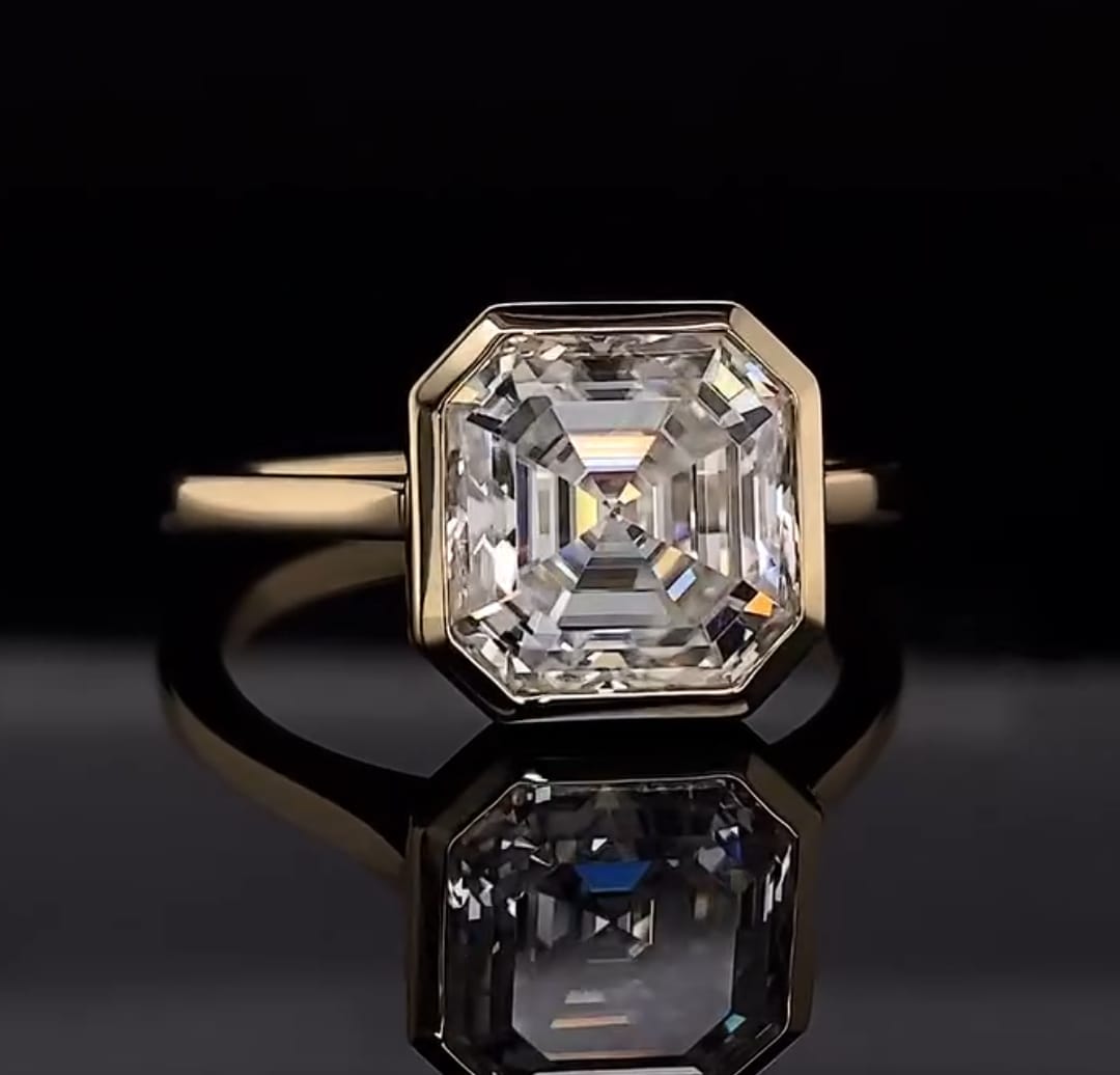 Front view of a 4 CT Asscher cut lab grown diamond set in a modern yellow gold bezel frame