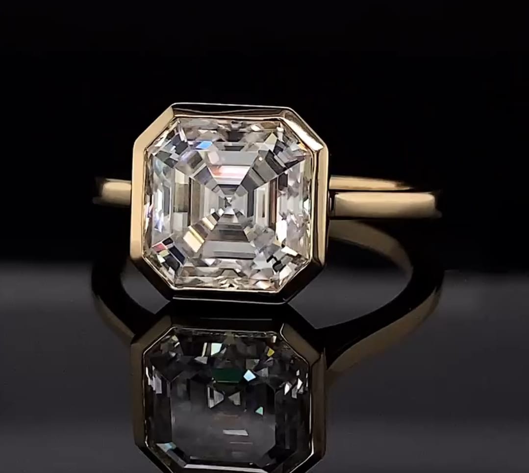 Top-down reflection shot highlighting the step-cut facets of a 4 carat Asscher lab diamond ring