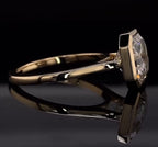 Side profile view showing the sleek bezel basket and plain yellow gold band of the Asscher diamond ring