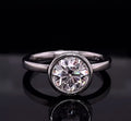 Front view of a 3 CT round cut lab grown diamond in a polished white gold bezel setting