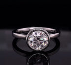 Front view of a 3 CT round cut lab grown diamond in a polished white gold bezel setting