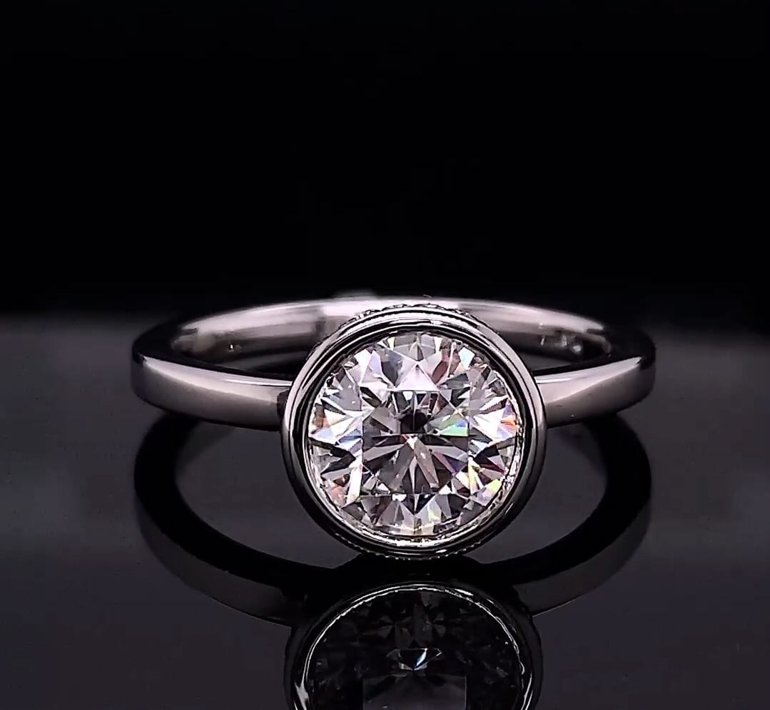 Front view of a 3 CT round cut lab grown diamond in a polished white gold bezel setting