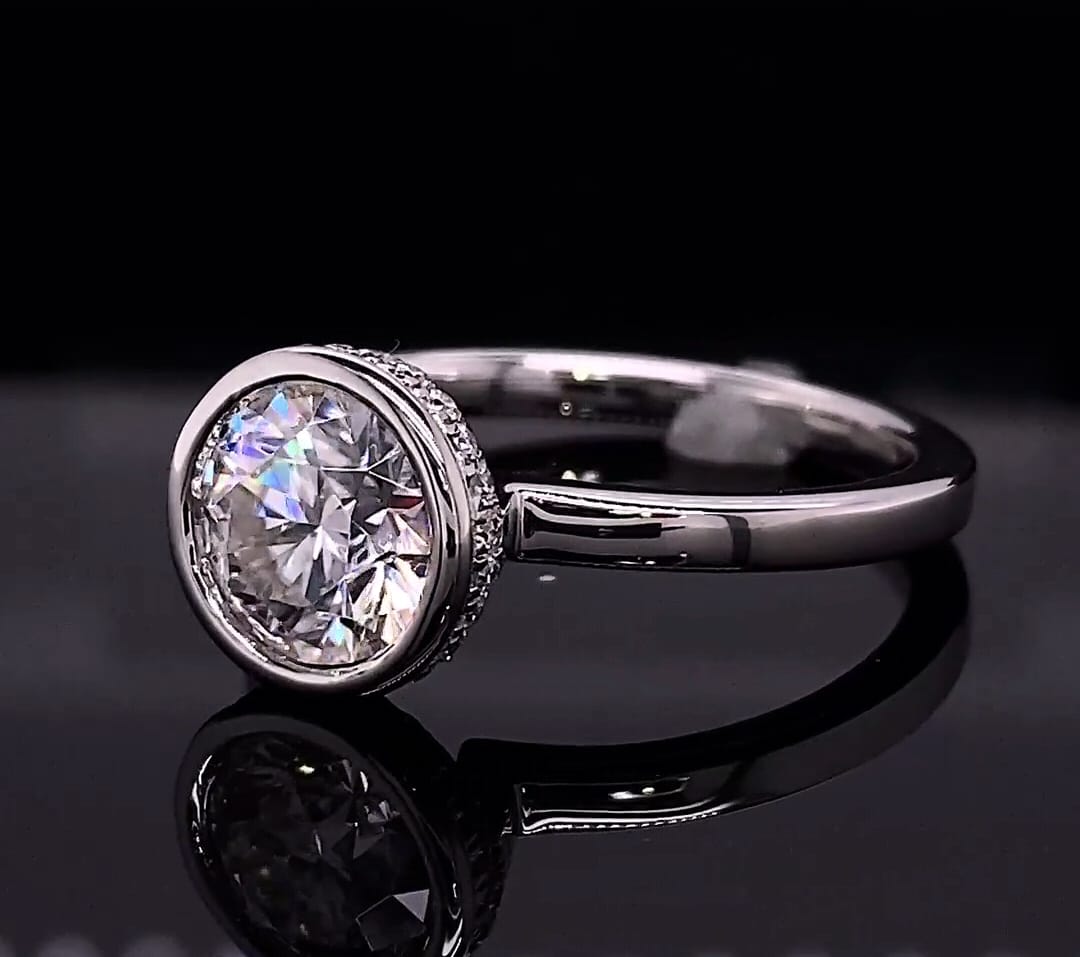 Side view showing the hidden micro-pavé diamond halo around the outer bezel wall