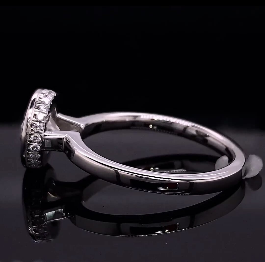 Complete side profile displaying the polished white gold band and pavé encrusted bezel basket