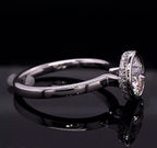 Side profile view showing the raised bezel setting and smooth shank on a reflective background