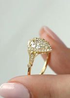 Angled view showcasing the brilliance of a 2 carat pear cut center diamond with milgrain halo