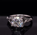 Front view of a 3 CT cushion cut lab grown diamond in a white gold botanical leaf setting