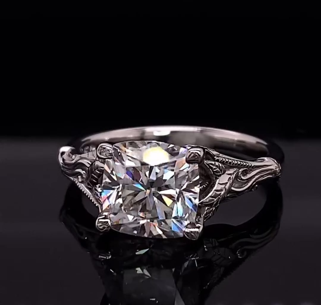 Front view of a 3 CT cushion cut lab grown diamond in a white gold botanical leaf setting