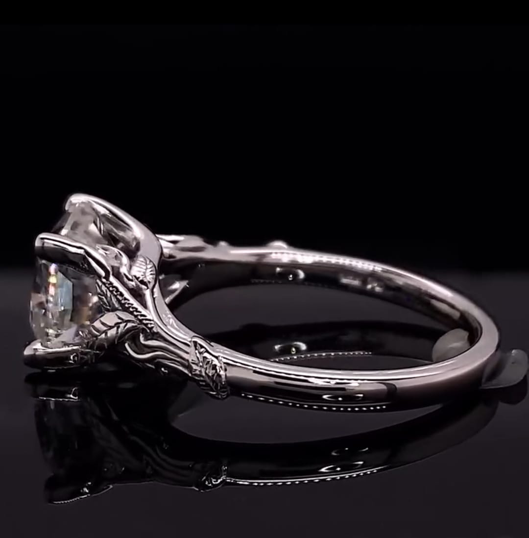 Profile view displaying the under-gallery craftsmanship and white gold band of the leaf filigree ring