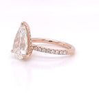 Side view showing the micropavé diamond band and rose gold setting of a 4 CT pear diamond ring