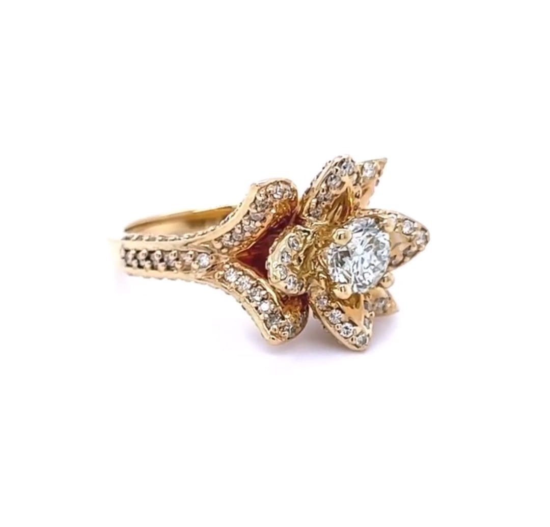 Three-quarter view of a 1.5 CT round cut lab grown diamond set inside a yellow gold blooming lotus setting with pavé petals