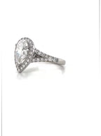 Side angle view highlighting the pavé-set split shank and white gold halo frame of a 3 CT pear ring