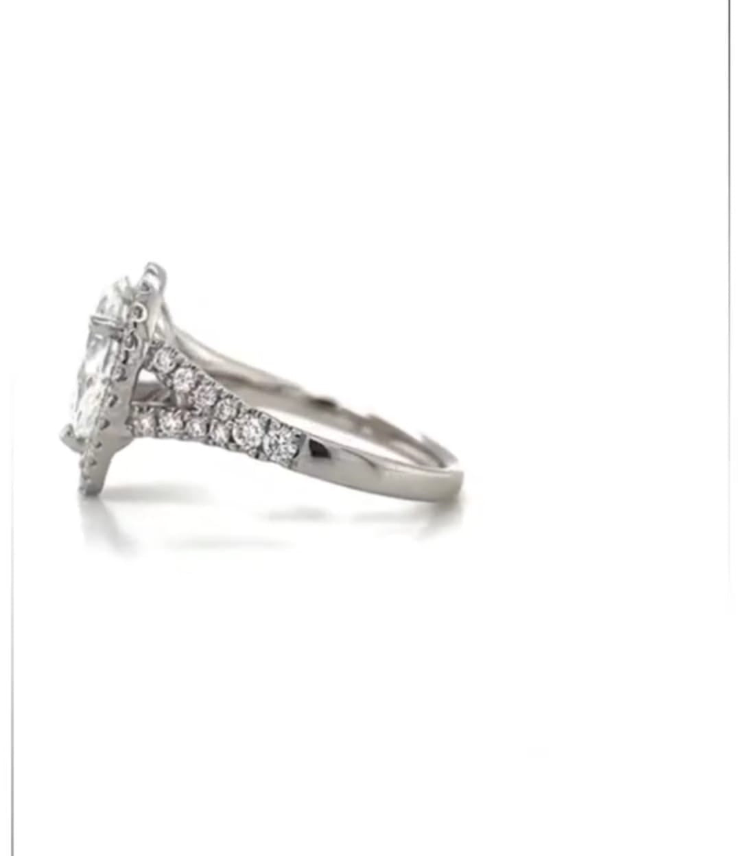Side profile view displaying the high-set basket and split shank design of a pear diamond halo ring