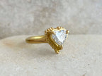 Angled view showing the smooth round band and beaded heart setting of a 2 carat lab diamond ring