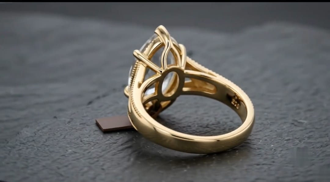 Reverse side angle view displaying the inner band hallmark and basket detail of a marquise diamond ring