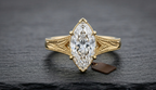 Direct top-down view of a 3 CT marquise lab diamond in a 6-prong setting with milgrain-bordered engraved shoulders