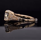 Side profile view displaying the tapered pavé shoulder accents, milgrain trim, and smooth yellow gold shank