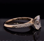 Angled view of a 3 CT emerald cut lab grown diamond ring with tapered micro-pavé shoulders in yellow gold