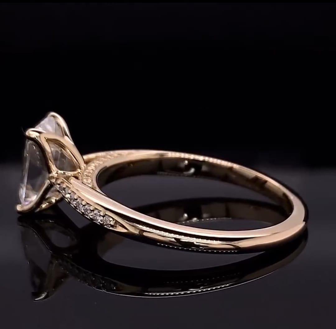 Reverse angle showing the polished yellow gold shank, micro-pavé split accents, and setting basket