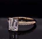 Three-quarter angle view displaying the delicate micro-pavé diamond band and yellow gold setting