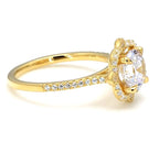Side profile view showing the elevated floral setting and micro-pave diamond band in gold.