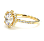 Three-quarter view of 3 carat round lab grown diamond ring showcasing side pavé diamonds and flower halo.