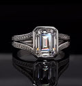 Direct top-down view showing step-cut facets of a 4 CT lab diamond enclosed in a protective bezel setting.