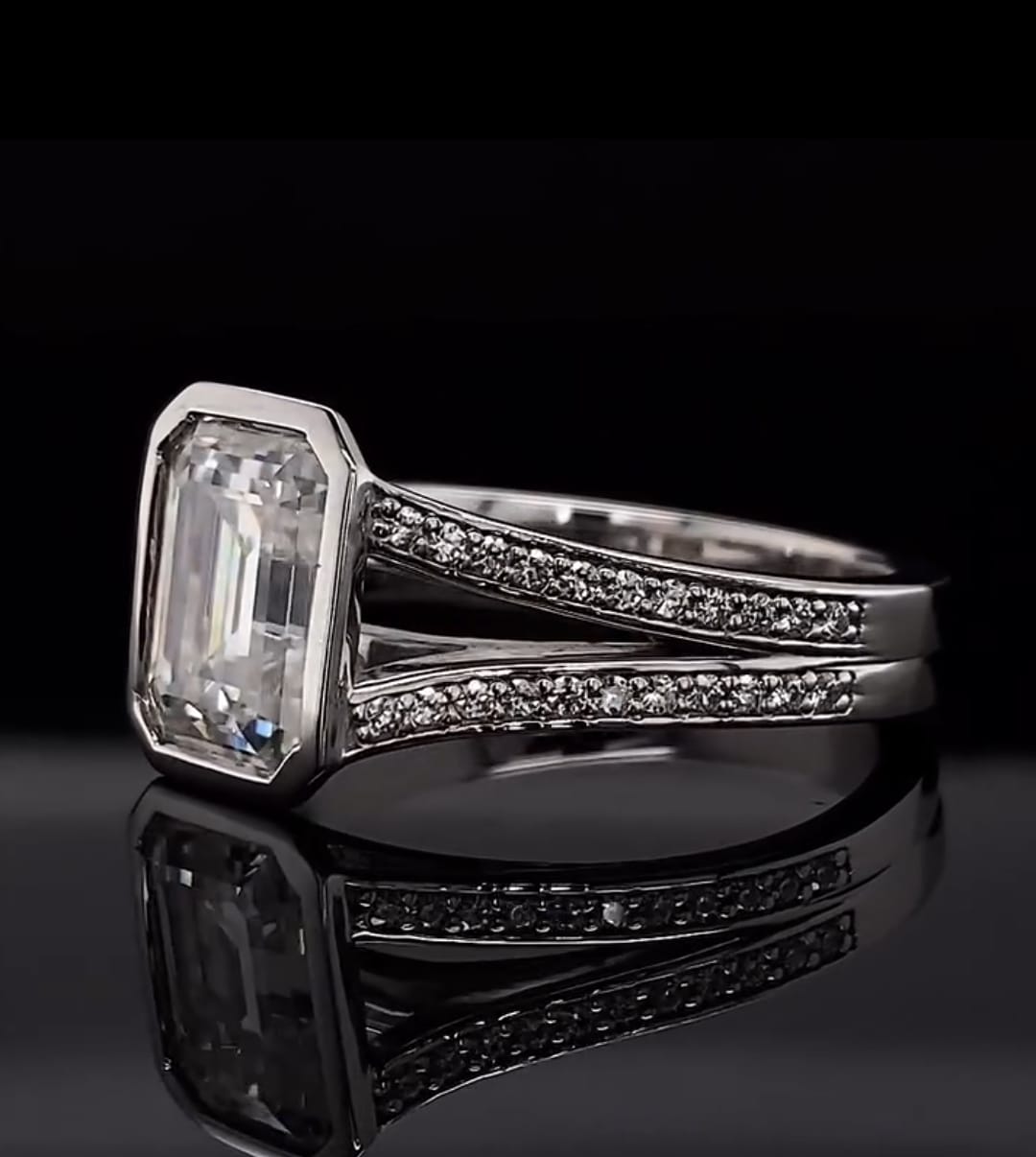 Three-quarter view highlighting the reflection and geometry of a bezel-set 4 CT emerald cut lab diamond ring.