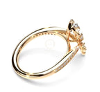 Side profile of a 2 Ct pear-cut lab-grown diamond engagement ring showing gold band with accent pavé diamonds and intricate setting.