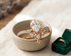 Close-up rendering of a 2 Ct pear lab-grown diamond engagement ring featuring a contoured crown design and accent side stones in polished gold.