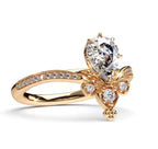 A rose gold engagement ring featuring a large round brilliant-cut diamond center stone and smaller diamonds along the band and bow-shaped setting