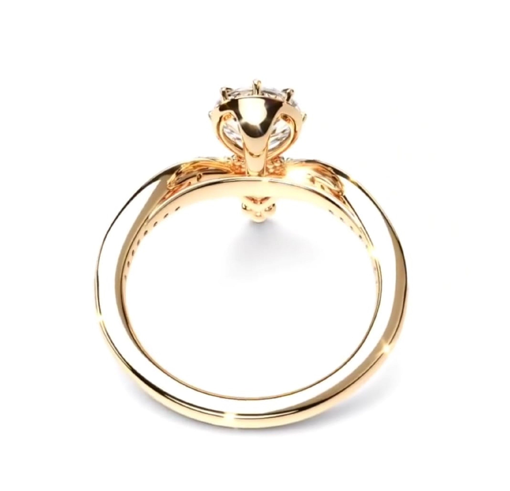 A gold ring with a unique band design and a decorative top, shown on a plain white background.
