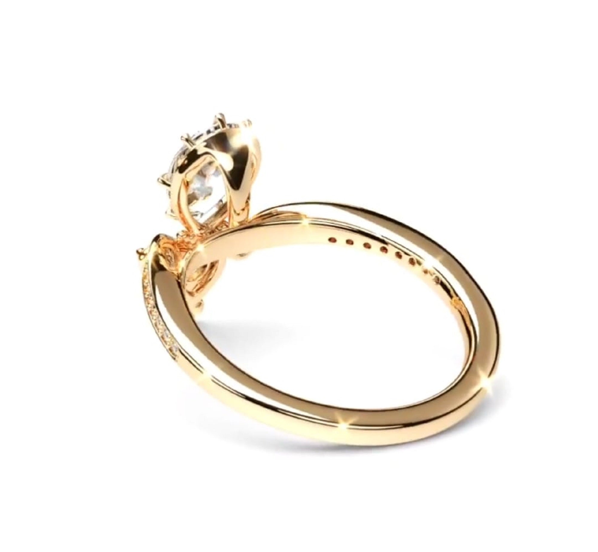 A yellow gold ring with a pear-cut clear gemstone in a prong setting