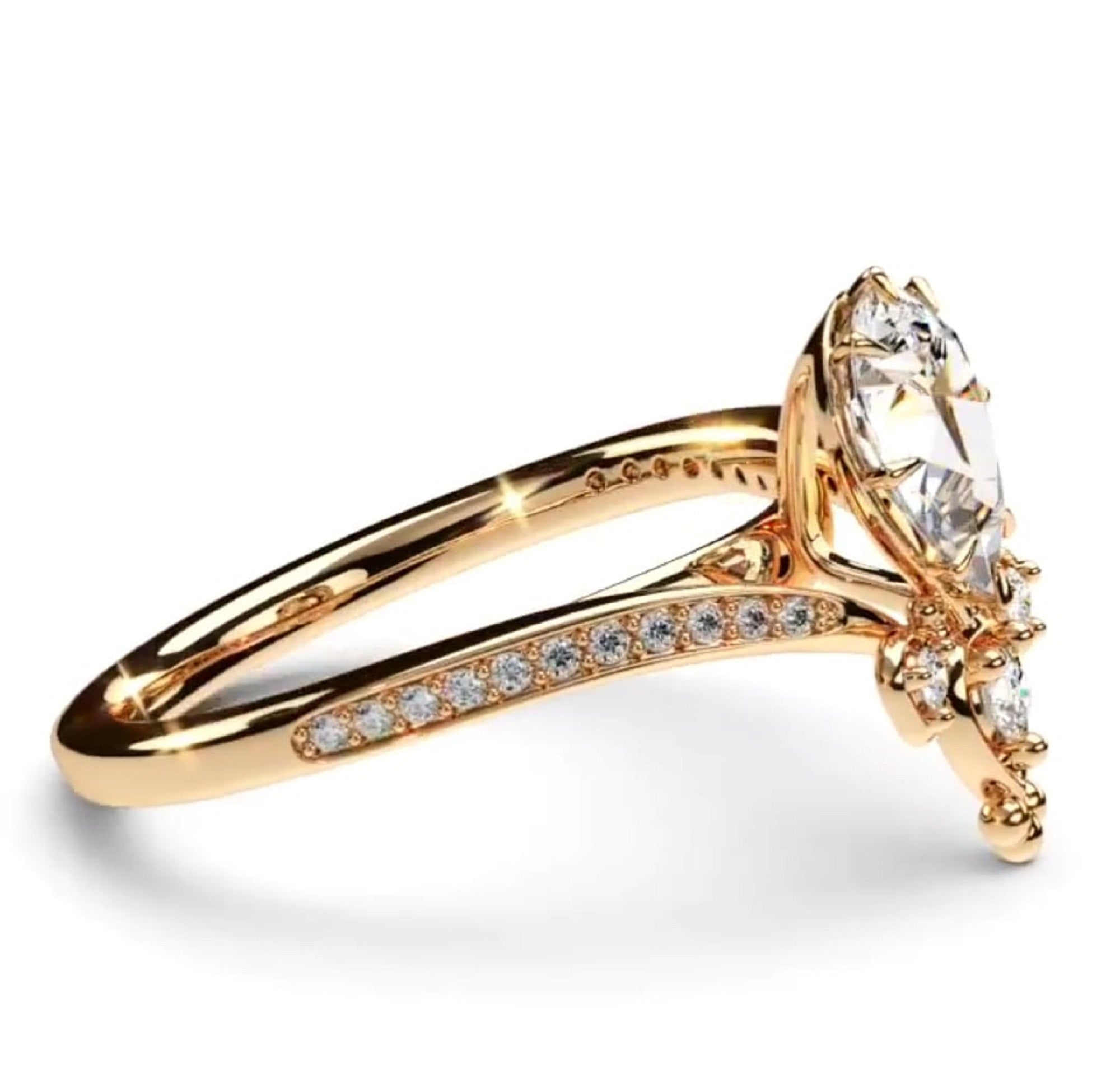 A rose gold engagement ring featuring a pear-cut lab gorwn diamond center stone and smaller round stones along the shank, set